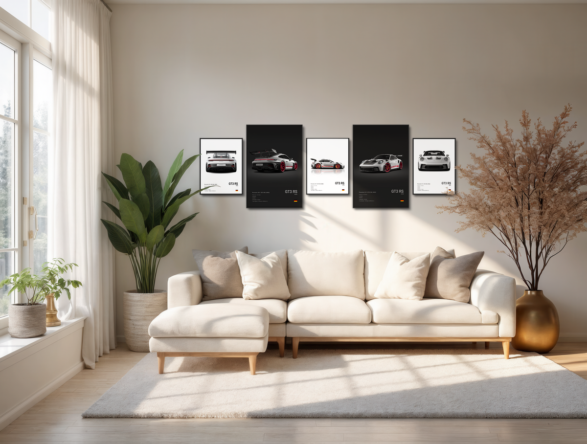 Living room with a beige sectional sofa, framed Porsche GT3 RS posters on the wall, and decorative plants.